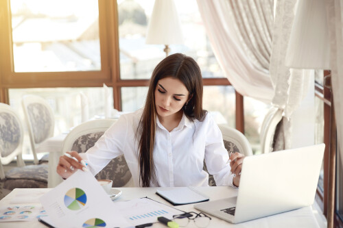 young-brunette-business-lady-is-analyzing-diagrammes-working-laptop.jpg